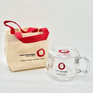 May include: A beige canvas tote bag with red handles and a clear glass mug with a handle. Both items feature a red circle logo and the text Lucent Technologies Bell Labs Innovations Customer Training & Information Products printed in black ink.
