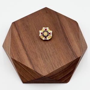 May include: A white ceramic mug with a black handle and the text "But First, Coffee" in a handwritten style. The mug is on a white surface. The mug is approximately 4 inches tall.