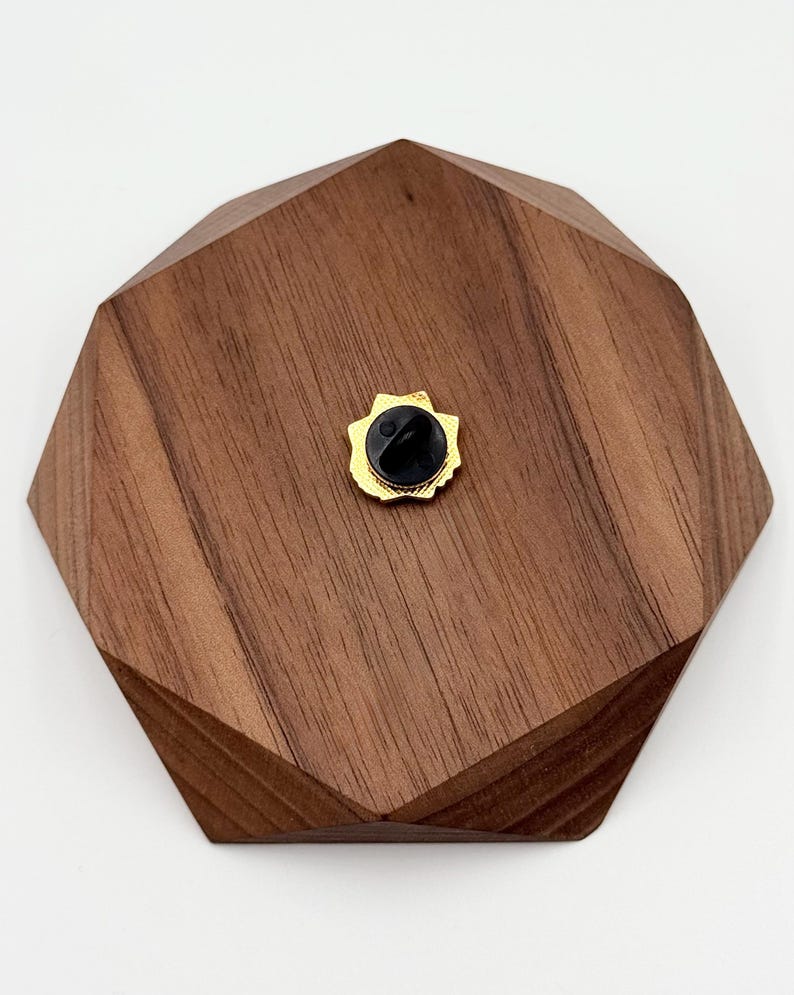 May include: A white ceramic mug with a black handle and the text "But First, Coffee" in a black, handwritten-style font. The mug is on a white surface.