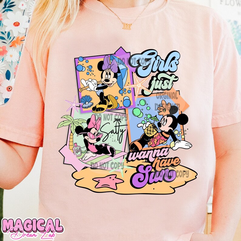 May include: Pink t-shirt with a graphic design featuring Mickey Mouse and Minnie Mouse in a summery scene. The text "Girls just wanna have sun" is featured on the design.