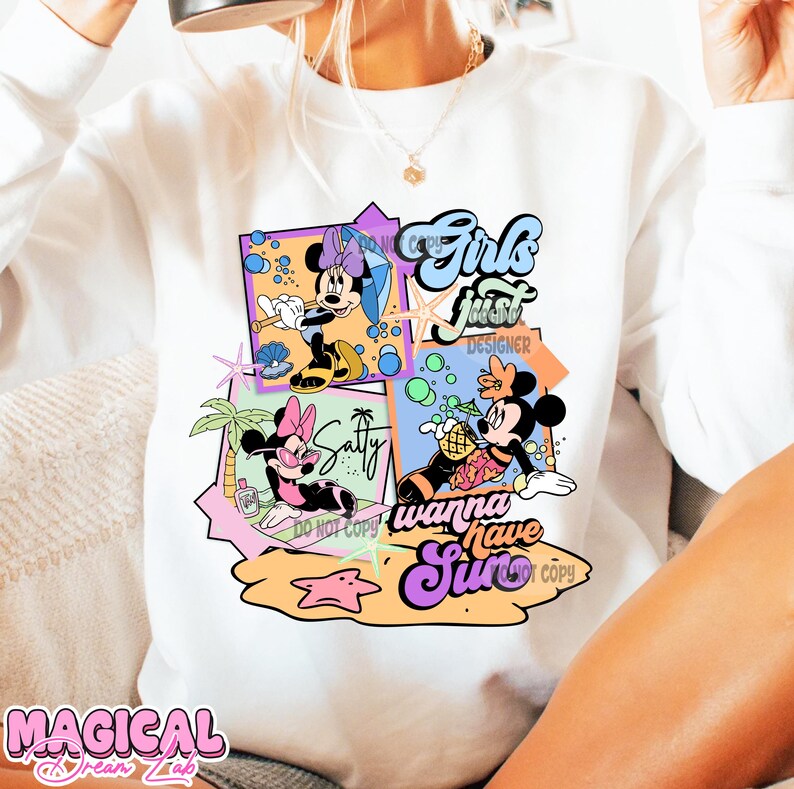 May include: White sweatshirt with a colorful graphic print featuring Mickey Mouse and Minnie Mouse characters. The graphic includes the text "Girls Just Wanna Have Sun".