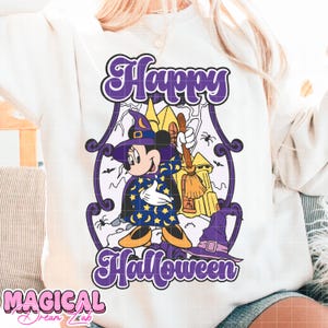 May include: White sweatshirt with a purple and black Halloween graphic. The graphic features Mickey Mouse dressed as a wizard with a broom, the words "Happy Halloween," and a castle. The text "Magical Dream Lab" is at the bottom.