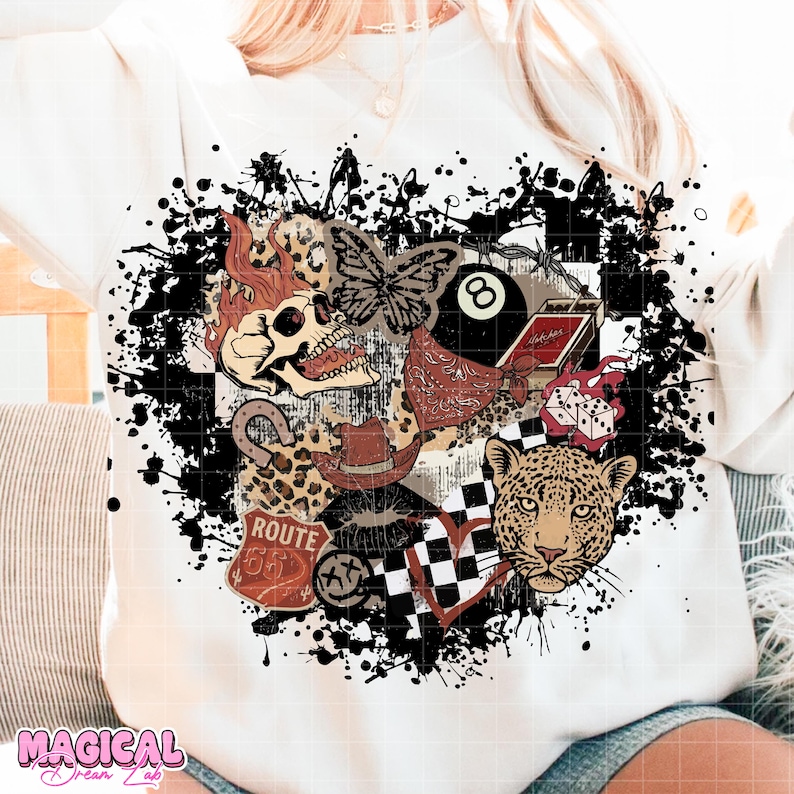 May include: White sweatshirt with a graphic design featuring a skull with flames, a butterfly, an 8-ball, a cowboy hat, a leopard, and Route 66 imagery. The design is surrounded by black paint splatters.