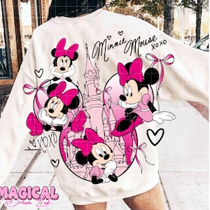 May include: White sweatshirt featuring a pink Minnie Mouse graphic with a castle backdrop. The design includes multiple Minnie Mouse illustrations, hearts, and the text "Minnie Mouse xoxo". The bottom of the sweatshirt has the text "MAGICAL Dream Lab".