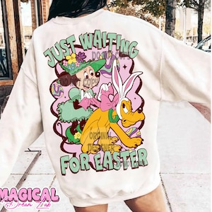 May include: White sweatshirt with a cartoon graphic of Mickey Mouse and Pluto dressed in Easter outfits. The text "Just Waiting For Easter" is printed on the sweatshirt.