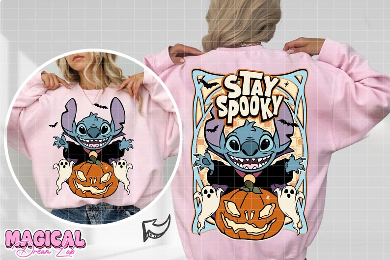 May include: Pink sweatshirt featuring a cartoon character with a pumpkin and ghosts. The design includes the text "Stay Spooky" and bats. The sweatshirt has long sleeves and a crew neck.