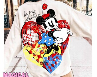 Può includere: Felpa color crema con grafica di Minnie Mouse che tiene un cuore bianco. Il design include cuori rossi, gialli e blu con la scritta "be my valentine". La felpa ha girocollo e maniche lunghe.