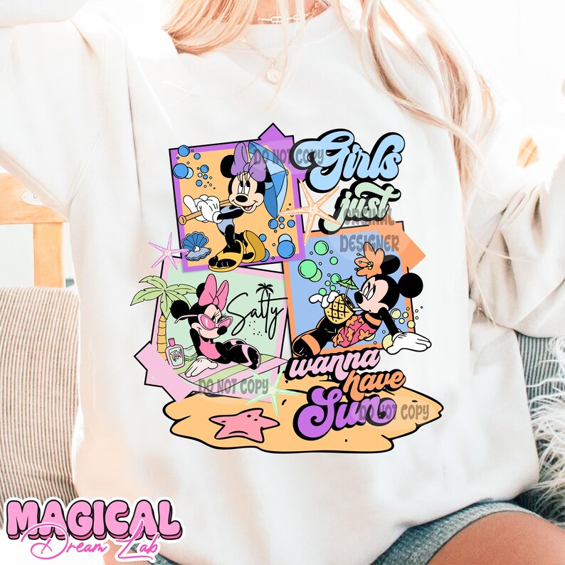 May include: A white sweatshirt with a colorful graphic design featuring Mickey Mouse and Minnie Mouse characters. The design includes the text "Girls just wanna have sun" and a beach scene with palm trees, a starfish, and a pineapple.