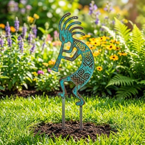 May include: A turquoise metal Kokopelli garden stake with a flute, standing in a garden. The figure has intricate cut-out designs and is mounted on two metal rods. The background features green grass and colorful flowers.