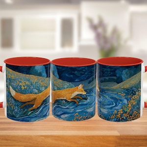 May include: White ceramic mug with a red interior and handle. The exterior features a detailed illustration of a fox running through a blue river, surrounded by yellow and blue foliage. The mug is set on a wooden surface.
