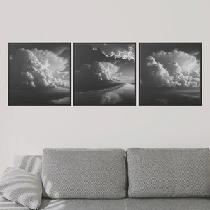 May include: A triptych of framed black and white cloudscape art. Each square frame displays a dramatic view of billowing clouds, with variations in light and shadow. The artwork evokes a sense of depth and atmospheric perspective, suitable for home decor.
