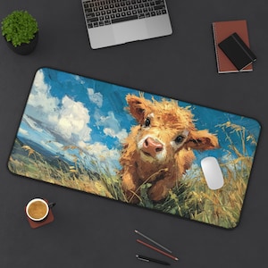 May include: A rectangular mouse pad featuring a painting of a brown cow in a field of tall grass under a blue sky with white clouds. The cow is looking directly at the viewer. A white mouse is on the right side of the pad.