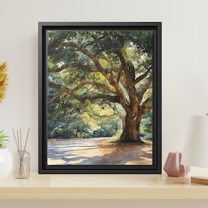 May include: A framed wall art print featuring a watercolor painting of a large, sprawling oak tree with thick, textured branches and dense green foliage, casting dappled shadows across a sunlit ground in a natural outdoor forest setting.