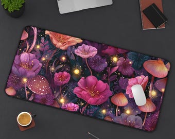 May include: A rectangular desk mat featuring a vibrant floral and mushroom design in shades of pink, purple, and orange. The mat includes a white computer mouse and is surrounded by office supplies.