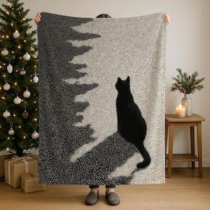 May include: A black and white patterned blanket featuring a silhouette of a black cat. The design has a tree-like shape on the left side, with a textured, swirling pattern. The cat is sitting and looking to the right.