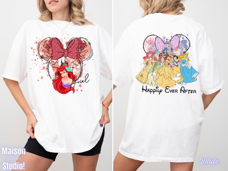 May include: White t-shirt featuring a Minnie Mouse-inspired design with Ariel and a red bow on the front. The back of the shirt displays Disney princesses with the text "Happily Ever After".