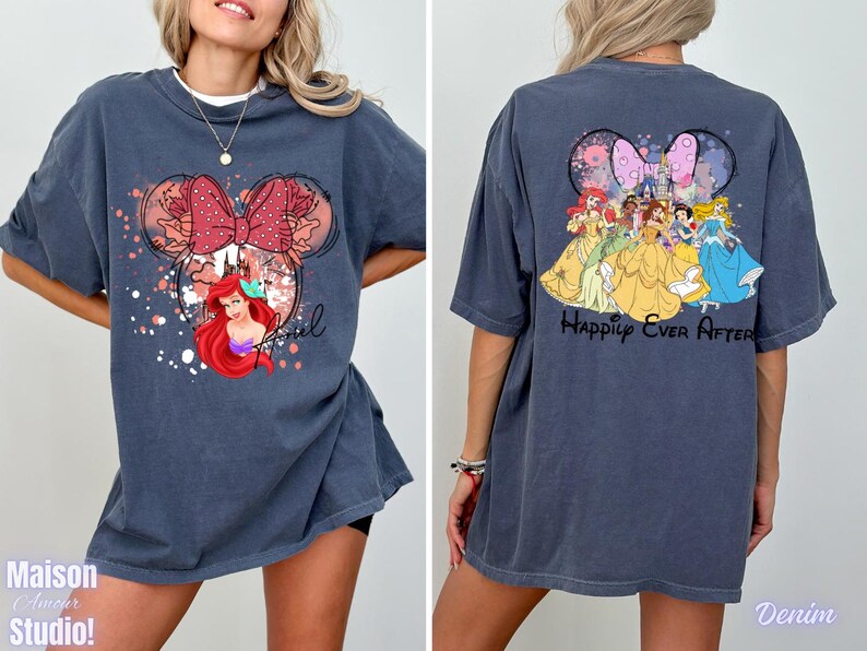 May include: Denim blue t-shirt featuring a Minnie Mouse design with Ariel and floral accents. The front design includes the word "Ariel". The back of the shirt displays Disney princesses with the text "Happily Ever After".