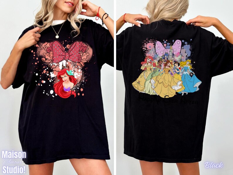 May include: Black t-shirt featuring a Minnie Mouse design with a red bow and Ariel the Little Mermaid. The back of the shirt displays several Disney princesses. The shirt has the text "Maison Studio!" on the front and "Black" on the back.