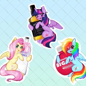 May include: Three die-cut stickers featuring cartoon ponies. One purple pony holds a Jack Daniel's bottle, a yellow pony holds an Absolut Vodka bottle, and a blue pony with a rainbow mane holds a red BuzzBallz Biggies strawberry cocktail container.