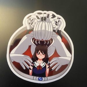 May include: A sticker featuring a cartoon illustration of a girl in a blue dress with a red bow, framed by a large, white, monster-like figure with black claws and a spotted head. The background is red and gray.