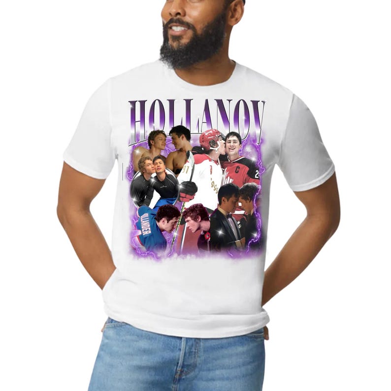 May include: White t-shirt featuring a collage of images with a purple and white design. The word "HOLLANOV" is printed in a purple, stylized font across the top. The shirt has a crew neck and short sleeves.
