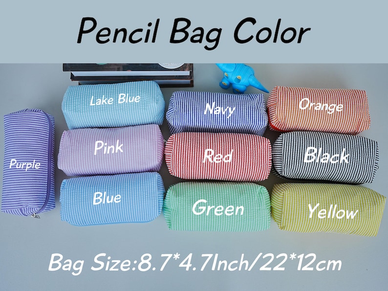 May include: A collection of colorful pencil bags in various colors, including purple, lake blue, navy, orange, pink, red, black, blue, green, and yellow. Each bag is striped and labeled with its color. The bag size is 8.7*4.7 inches.