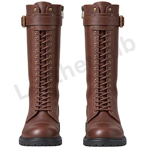 May include: A pair of knee-high brown boots featuring a front lace-up design with brass-toned eyelets, a buckled strap across the upper shaft, and a side zip closure. The boots have a rounded toe, a smooth finish, and a thick black lug sole.