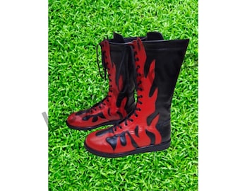May include: A pair of black and red wrestling boots with a flame design. The boots are laced up and have a thick sole.