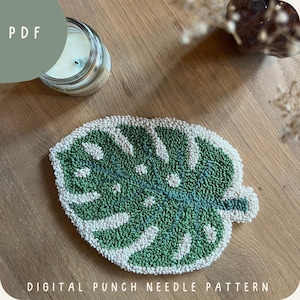 May include: A digital punch needle pattern for a green monstera leaf. The pattern is on a white background and is ready to be stitched.