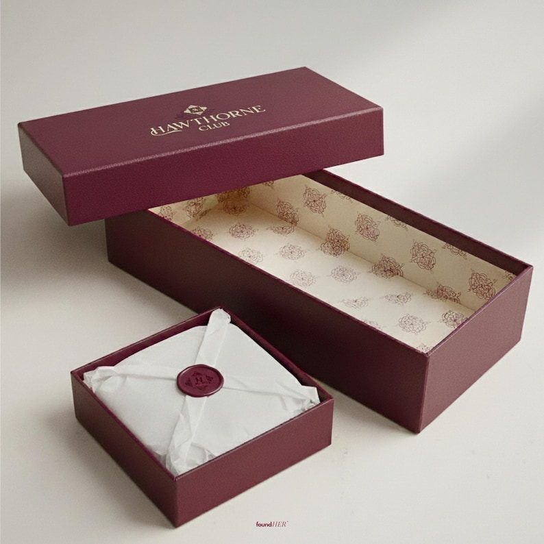 A luxurious packaging mockup in old money style. A premium box design displays all three versions of the included logo — main, tagline, and icon — seamlessly integrated to highlight how the logos can be applied across physical products.