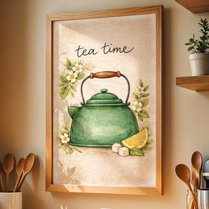 May include: Framed watercolor print featuring a green teapot with a wooden handle, a lemon slice, and the words "tea time." The artwork is surrounded by white flowers and green leaves, set against a beige background.