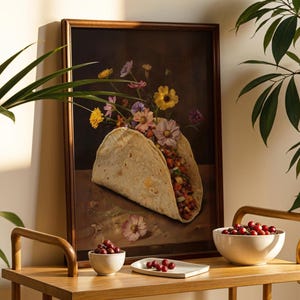 May include: A framed artwork depicts a taco overflowing with colorful flowers. The taco is set against a dark background, with a wooden frame. A wooden table holds a bowl of red berries and a small plate with more berries.