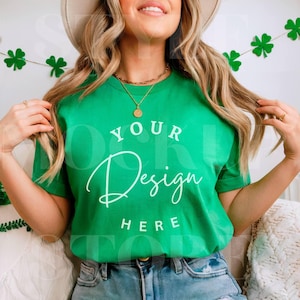 May include: A woman wearing a green t-shirt with the text "YOUR Design HERE" printed on the front. She is wearing a straw hat and has long blonde hair.