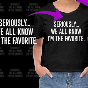 May include: Black t-shirt with white text that reads "SERIOUSLY... WE ALL KNOW I'M THE FAVORITE."