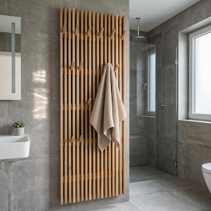 May include: A wooden coat rack fixed to a wall, featuring multiple pegs. A beige towel is hanging from one of the pegs. The rack is constructed from vertical wooden slats and is in a modern bathroom with grey tiles.