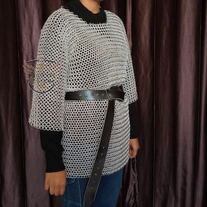 Person wearing a chainmail shirt over a medieval gambeson at a Renaissance Faire event.