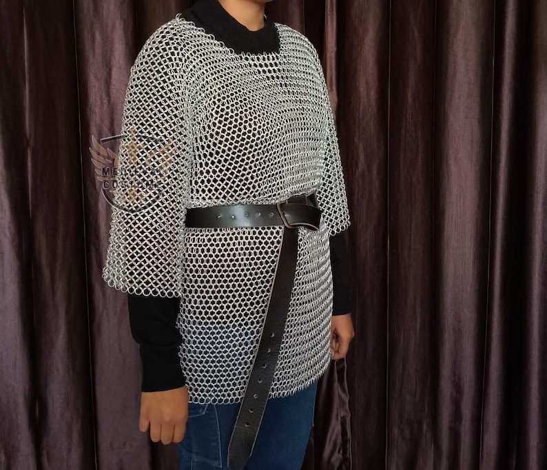 Person wearing a chainmail shirt over a medieval gambeson at a Renaissance Faire event.