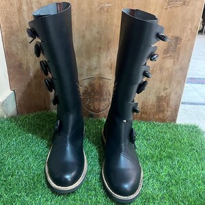 Detailed look at lace-up and buckle fastenings on historical leather long boots for LARP and Ren Fair