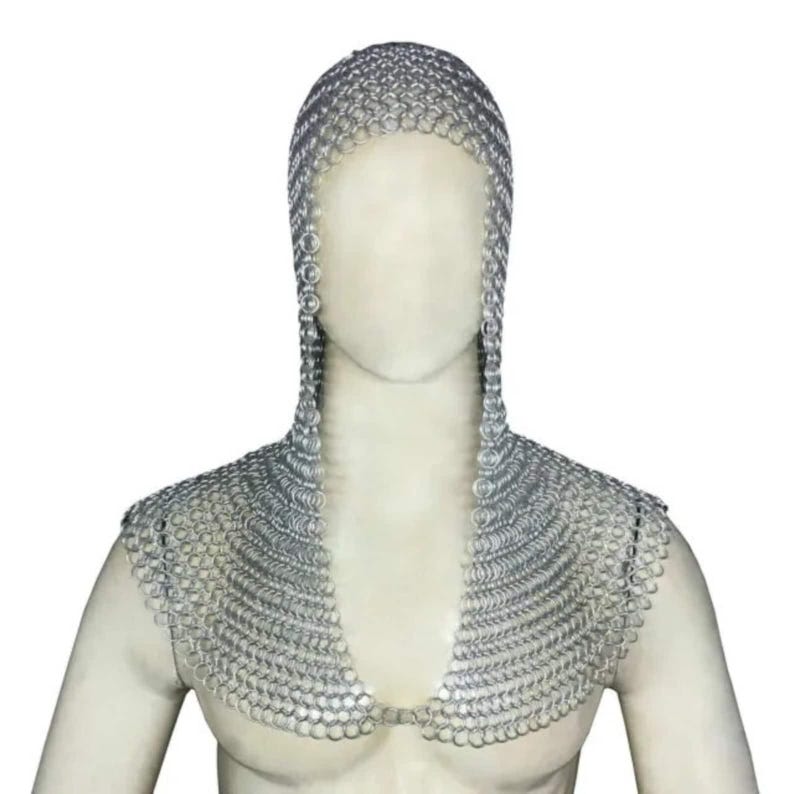 May include: A silver chainmail coif with a hood and a collar. The coif is made of interlocking metal rings.