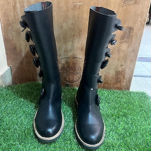 Pair of Viking medieval leather tall boots with rustic stitching and durable sole for reenactment and cosplay