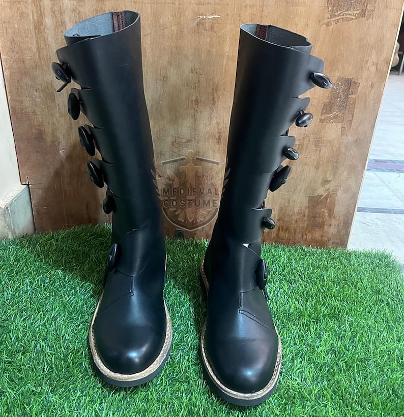 Pair of Viking medieval leather tall boots with rustic stitching and durable sole for reenactment and cosplay