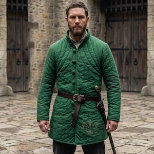 May include: A quilted green tunic with a brown leather belt and a sword in a sheath. The tunic has a diamond pattern and button closures. The image is set against a stone background.