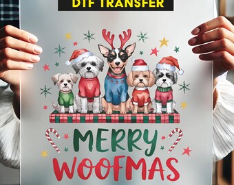 May include: A clear sheet with a colorful graphic featuring five dogs dressed in Christmas attire. The dogs are wearing sweaters and Santa hats, with the text "MERRY WOOFMAS" in red and green. The top of the sheet reads "READY TO PRESS DTF TRANSFER".