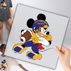 May include: A cartoon illustration of Mickey Mouse in a Pittsburgh Steelers football uniform, holding a football. The image features a yellow jersey, blue pants, and a blue helmet with the text "Pittsburgh Football" and the year "1933".