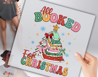 May include: A square print with the text "All Booked For Christmas" in a retro font. The design features a Christmas tree made of books, decorated with lights, bows, and a star on top. The color palette includes red, green, orange, and pink.