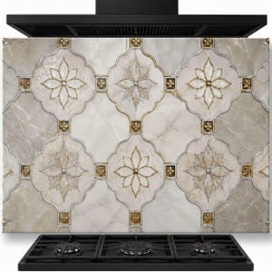 May include: A kitchen splashback panel featuring a repeating pattern of beige and cream marble-effect tiles with quatrefoil shapes. Each tile is accented with gold-toned floral medallions and thin metallic borders, positioned above a black gas hob.