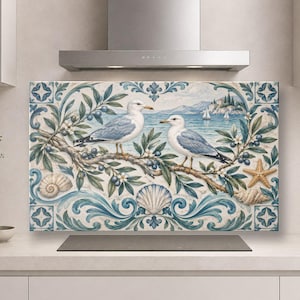 May include: A rectangular kitchen splashback panel featuring a coastal scene with two seagulls perched on an olive branch. The design includes blue and white scrollwork, seashells, a starfish, and a distant seascape with sailboats.