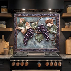 May include: A decorative kitchen backsplash featuring a relief sculpture of grapes and leaves. The grapes are a deep purple, and the leaves are bronze and green. The frame is a dark bronze color, and the background is a mottled green and gray.