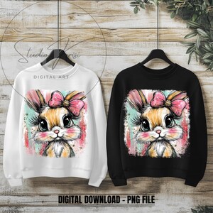May include: Two sweatshirts, one white and one black, each featuring a cute bunny illustration. The bunny has large eyes, long eyelashes, and a pink bow. The words "DIGITAL ART" and "DIGITAL DOWNLOAD - PNG FILE" are visible.