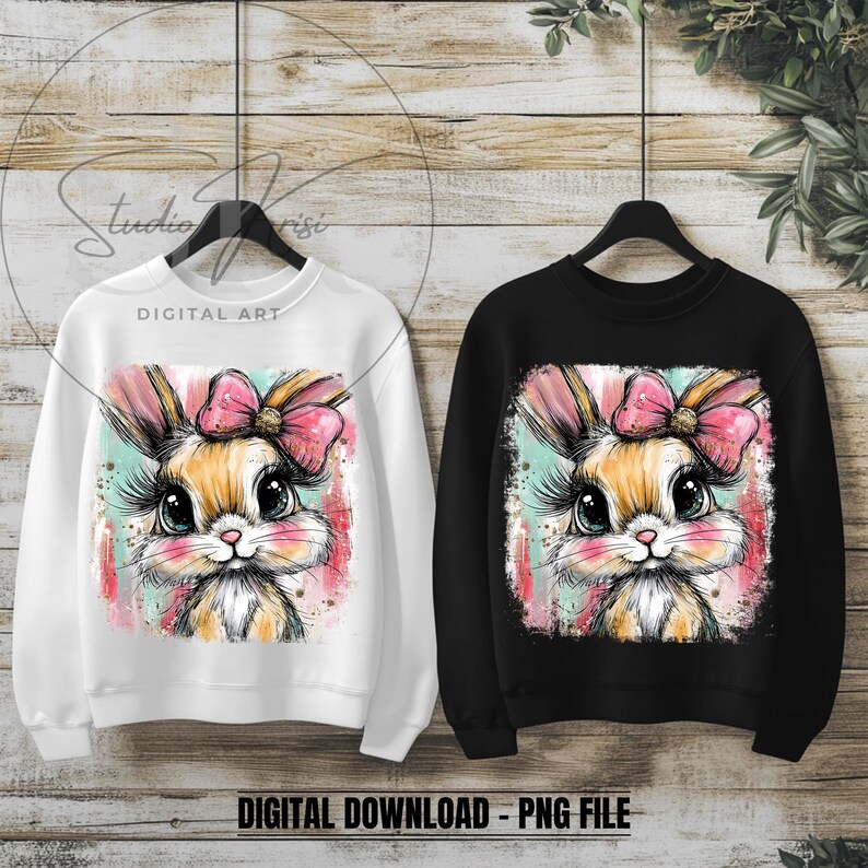 May include: Two sweatshirts, one white and one black, each featuring a cute bunny illustration. The bunny has large eyes, long eyelashes, and a pink bow. The words "DIGITAL ART" and "DIGITAL DOWNLOAD - PNG FILE" are visible.